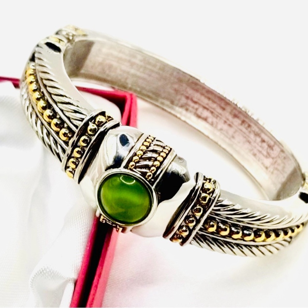 two-tone hinged bangle ,prominent central green stone,leaf design accents